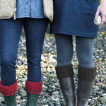 Two people wearing boots with boot cuff
