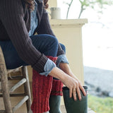 Woman putting on boots with boot cuff