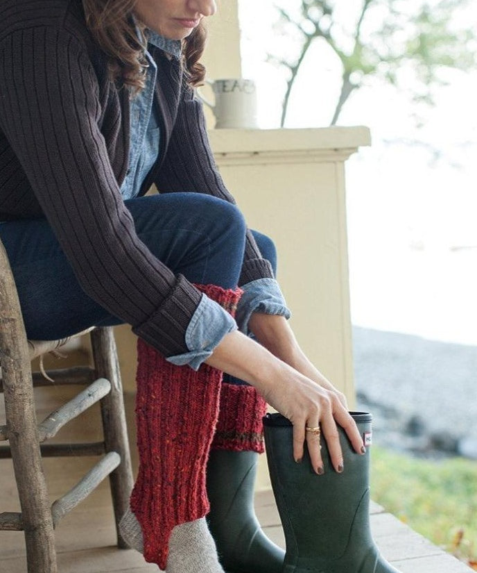 Woman putting on boots with boot cuff