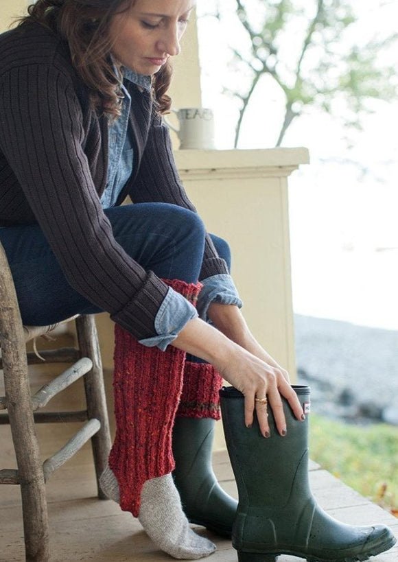 Woman putting on boots with boot cuff