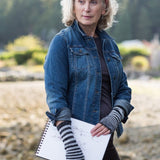 A woman wearing knitted fingerless gloves