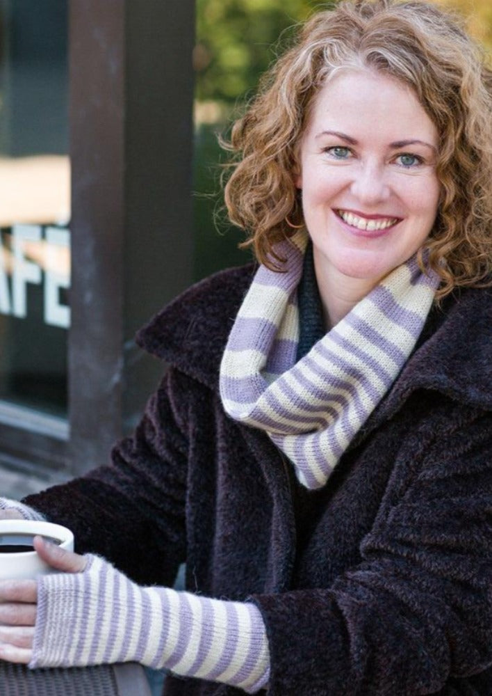 A woman wearing a knitted cowl and mittens