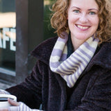 A woman wearing a knitted cowl and mittens