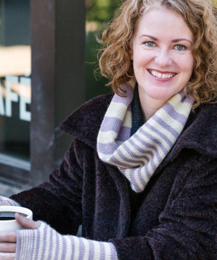 A woman wearing a knitted cowl and mittens