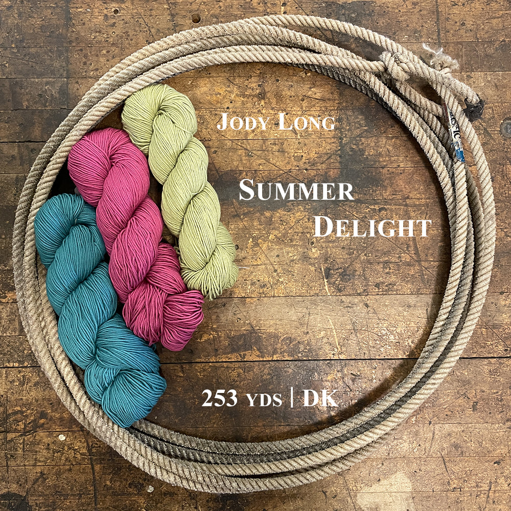 Three colorful hanks of Jody Long Summer Delight yarn in a lasso on a wooden surface