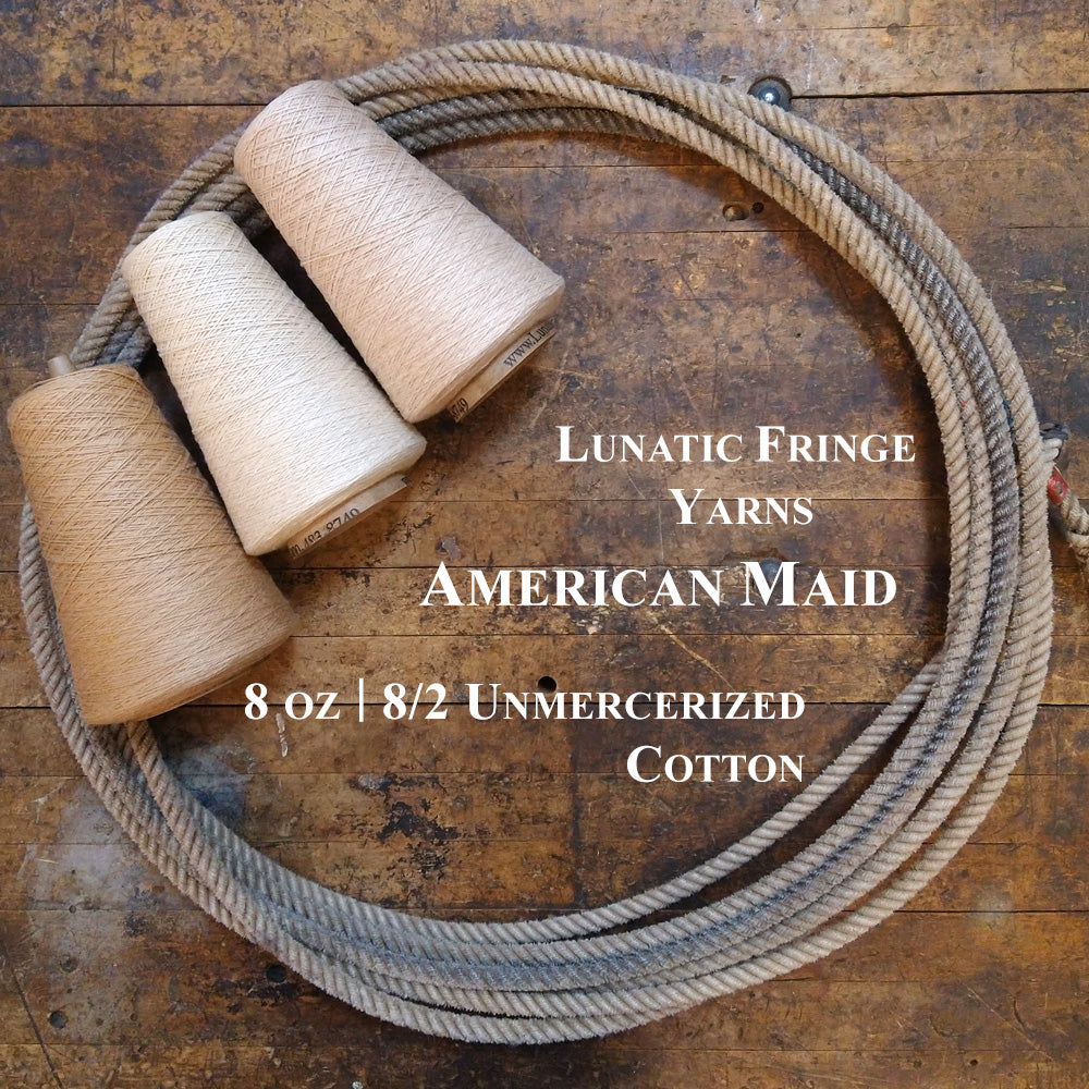 Three natural yarn cones of American Maid Lunatic Fringe Yarn