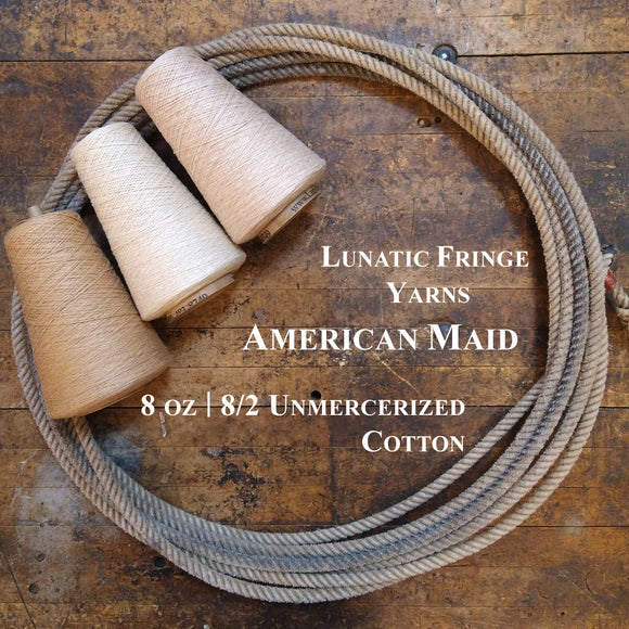 Three natural yarn cones of American Maid Lunatic Fringe Yarn