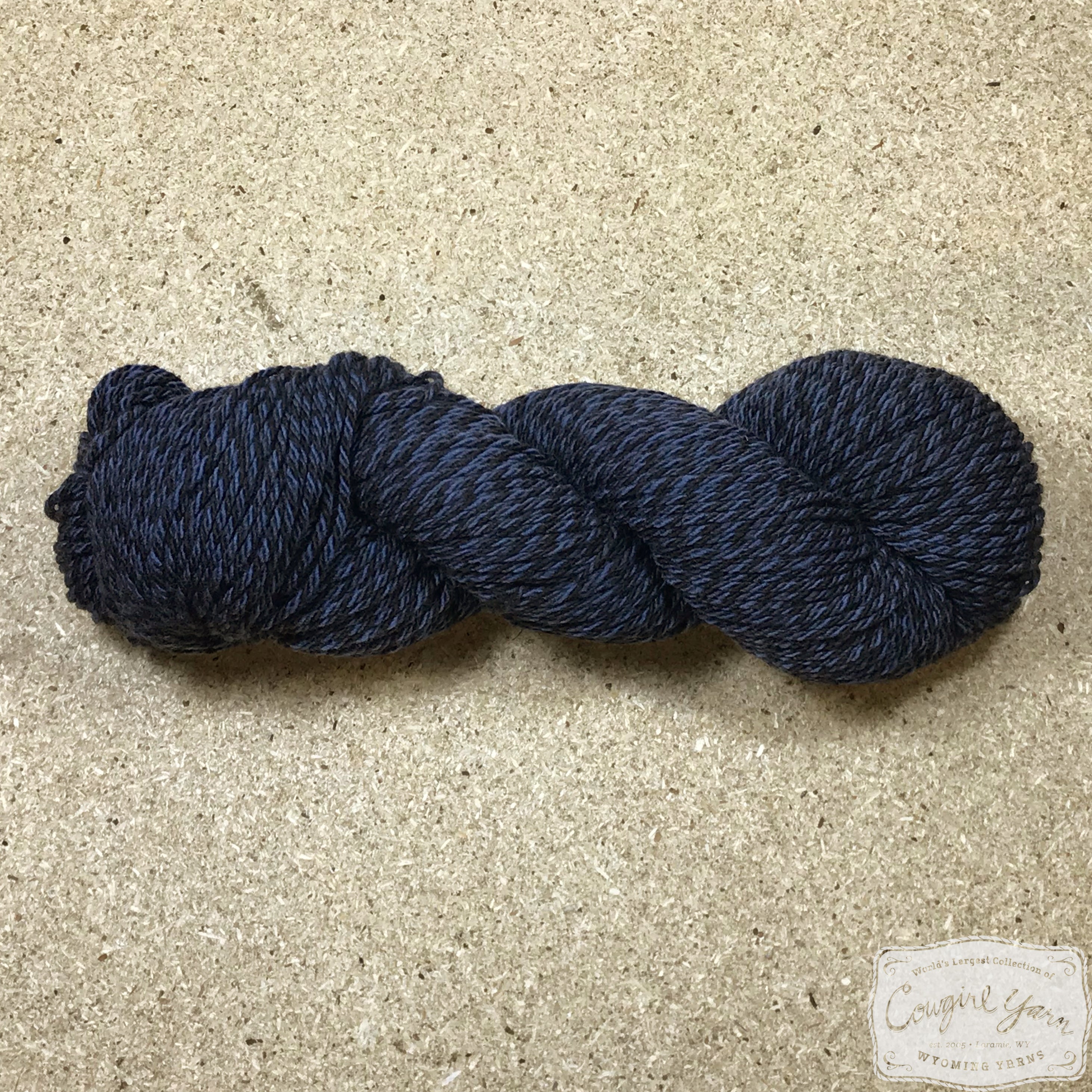 A navy blue tweed skein of Mountain Meadow Wool Tweed Worsted yarn