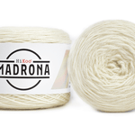 A photo of two white cakes of Hikoo Madrona yarn