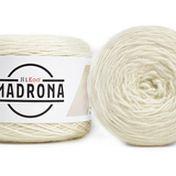 A photo of two white cakes of Hikoo Madrona yarn