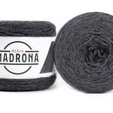 A photo of two dark gray cakes of HiKoo Madrona yarn