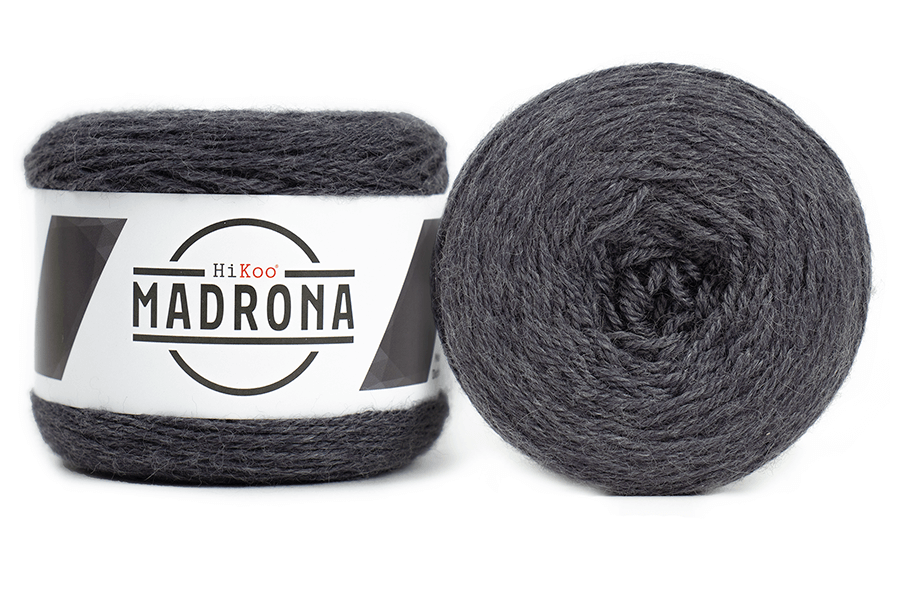 A photo of two dark gray cakes of HiKoo Madrona yarn