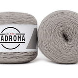 A photo of two gray cakes of HiKoo Madrona yarn