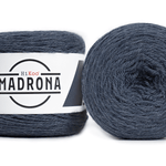 A photo of two blue cakes of Hikoo Madrona yarn