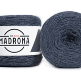A photo of two blue cakes of Hikoo Madrona yarn