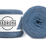 A photo of two blue cakes of HiKoo Madrona yarn