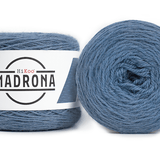 A photo of two blue cakes of HiKoo Madrona yarn