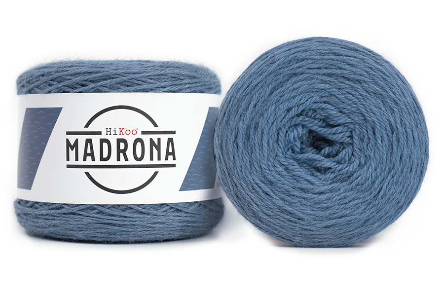 A photo of two blue cakes of HiKoo Madrona yarn