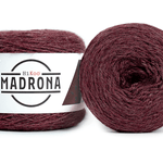 A photo of two red cakes of HiKoo Madrona yarn
