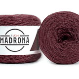 A photo of two red cakes of HiKoo Madrona yarn