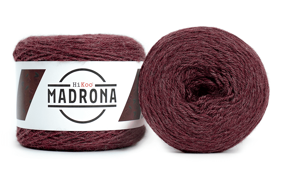 A photo of two red cakes of HiKoo Madrona yarn