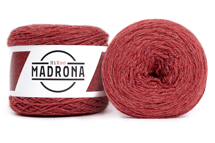 A photo of two red cakes of HiKoo Madrona yarn