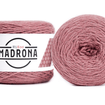 A photo of two pink cakes of HiKoo Madrona yarn