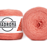 A photo of two salmon colored cakes of HiKoo Madrona yarn