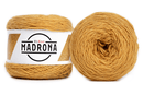 A photo of two yellow cakes of HiKoo Madrona yarn