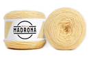 A photo of two light yellow cakes of HiKoo Madrona yarn