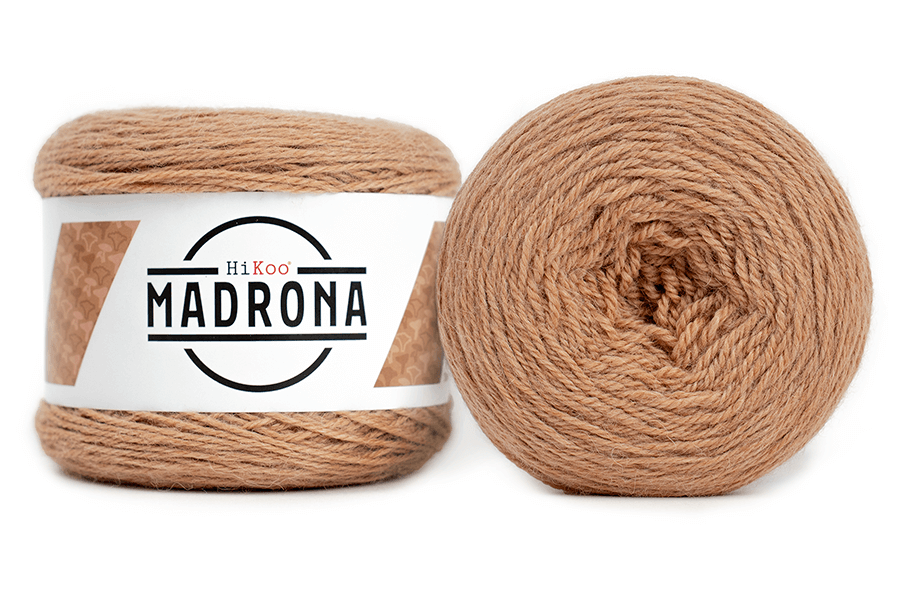 A photo of two light brown cakes of HiKoo Madrona yarn