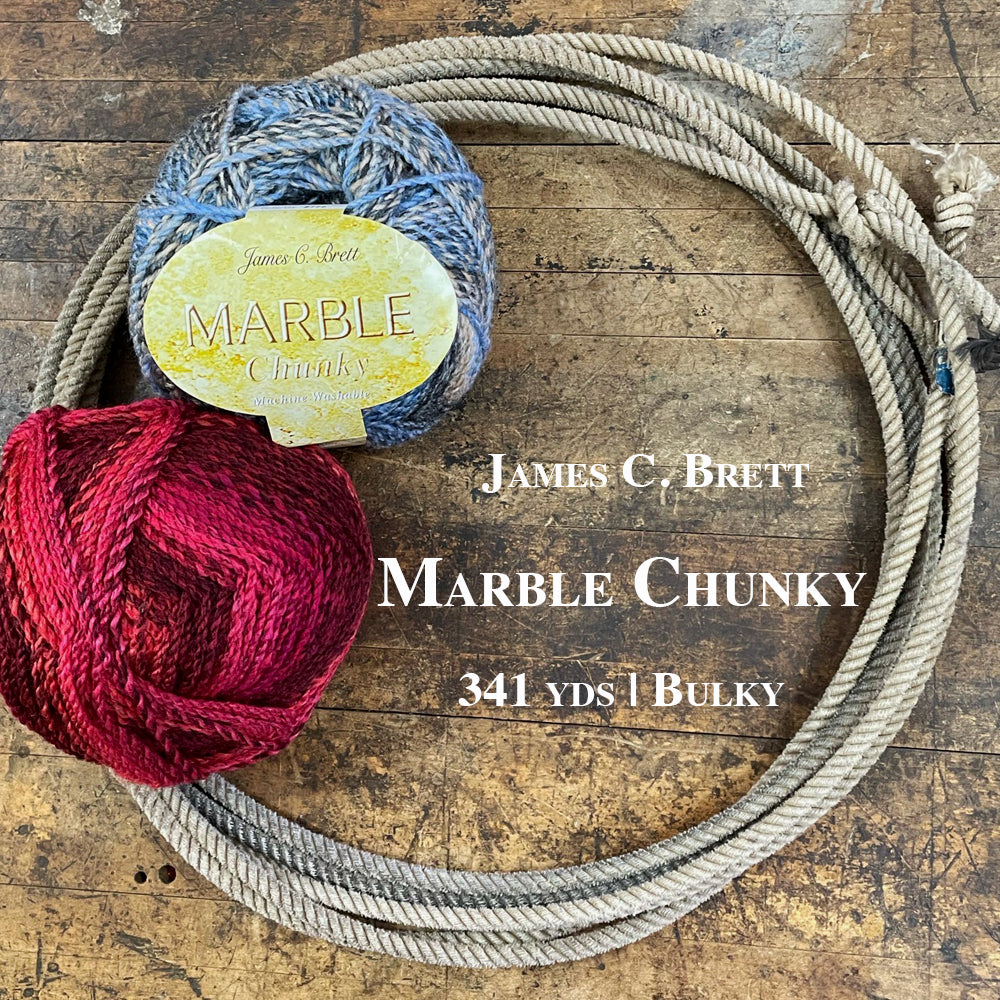 Two yarn balls of Marble Chunky inside a lasso on a wooden surface.