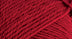 A close-up photo of a redsample of Nature Spun yarn