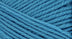 A close-up photo of a blue sample of Nature Spun yarn