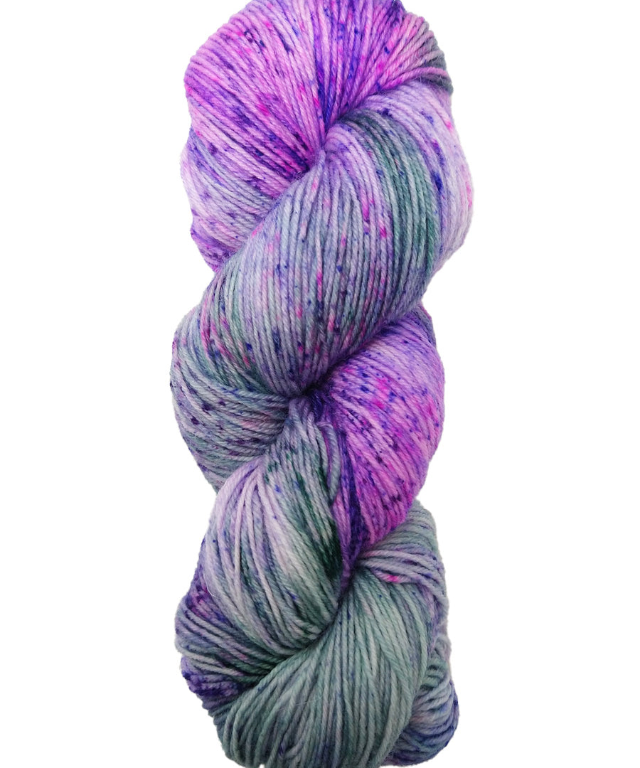 Hank of the colorway Boswell- variegated purple and light green with speckles of dark purple and hot pink