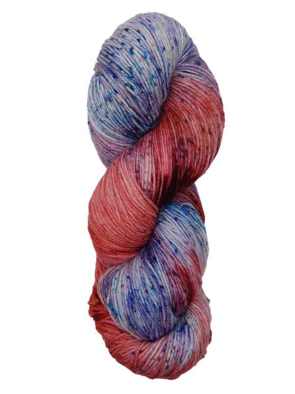 Hank of the colorway Depot- variegated salmon and light blue with speckles of red, purple, and bright blue.