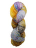 Hank of the colorway LaPrele- variegated yellow and light pink. Yellow sections have speckles of orange and dark brown, and light pink sections have speckles of hot pink, bright blue, and purple.