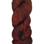 A colorful skein of dark reds and orange Malabrigo Rios yarn