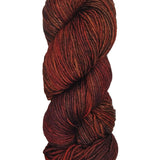 A colorful skein of dark reds and orange Malabrigo Rios yarn