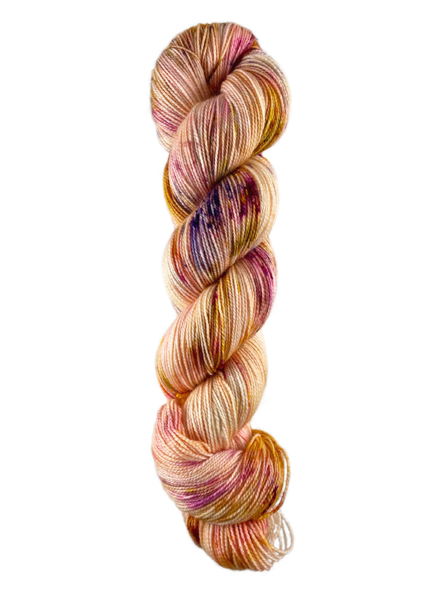A skein of Western Sky Knits Aspen Sock yarn in Peachy
