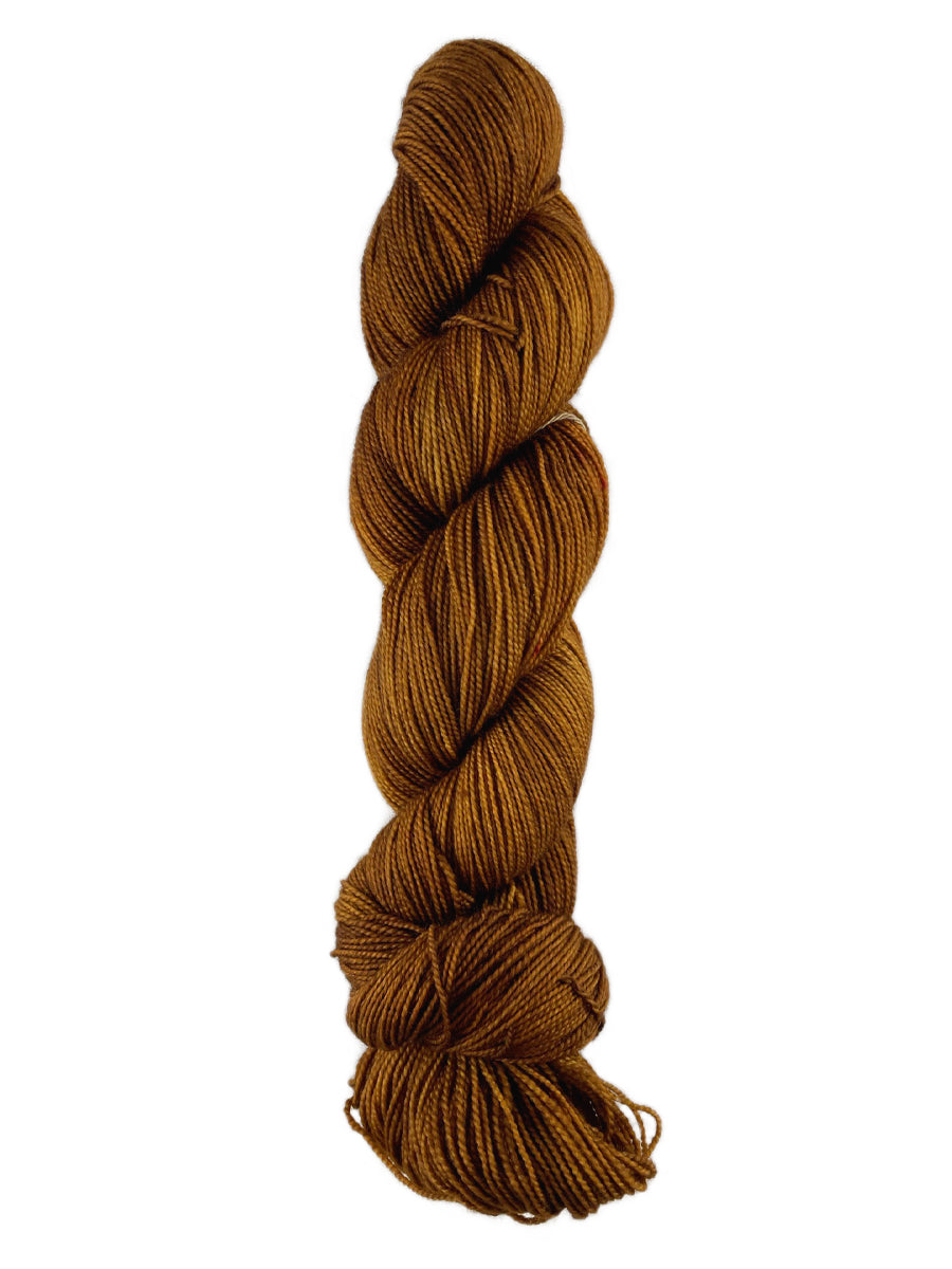 A skein of Western Sky Knits Aspen Sock yarn in Winter Wheat