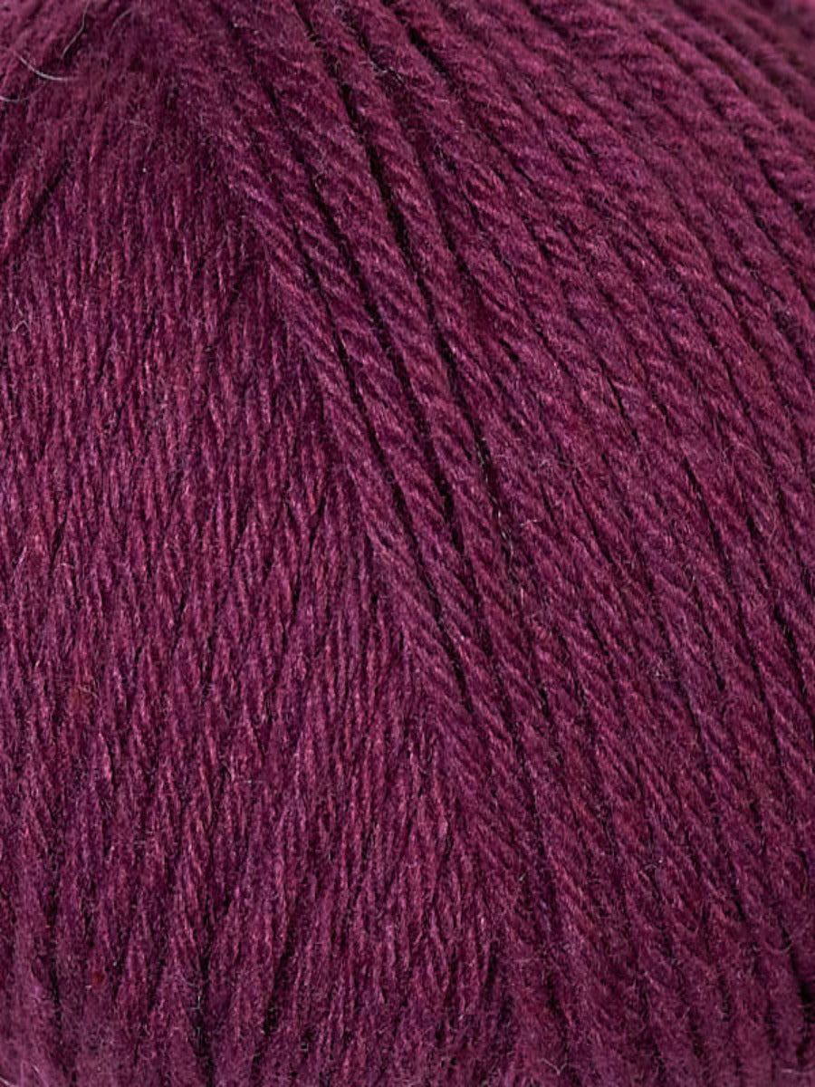 Close up of Berroco Renew yarn, color 1347 Chameleon- berry wine red yarn