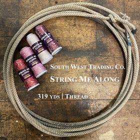 Four colorful cones of SWTC String Me Along sequin thread in a lasso on a wooden surface
