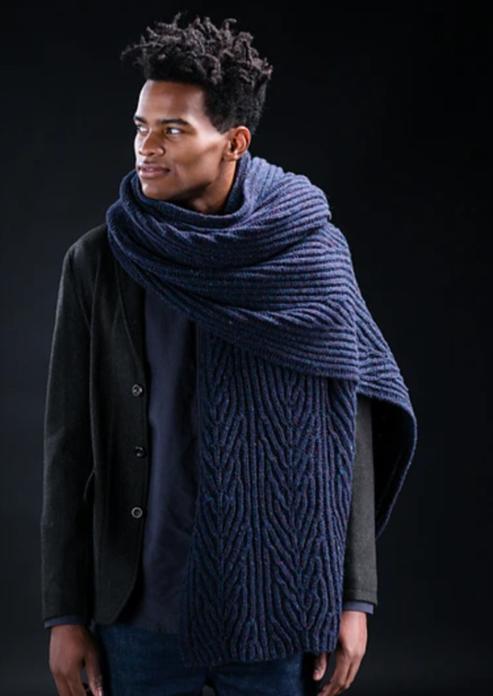 A man wearing a knitted wrap