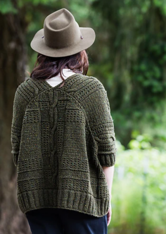 A woman wearing a knitted sweater