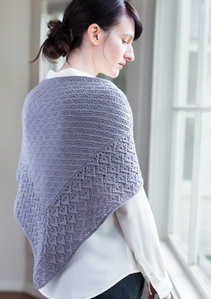 A woman wearing a knitted shawl