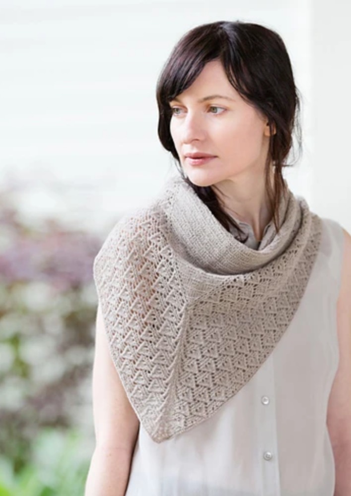 A woman wearing a knitted shawl