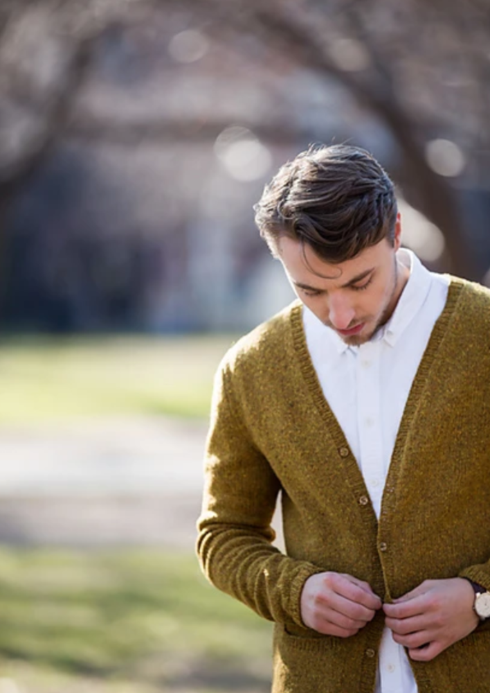 A man wearing a knitted cardigan