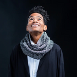 A man wearing a a knitted cowl