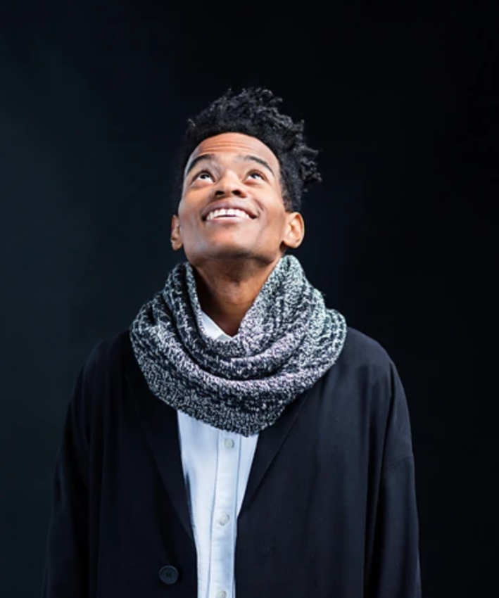 A man wearing a a knitted cowl